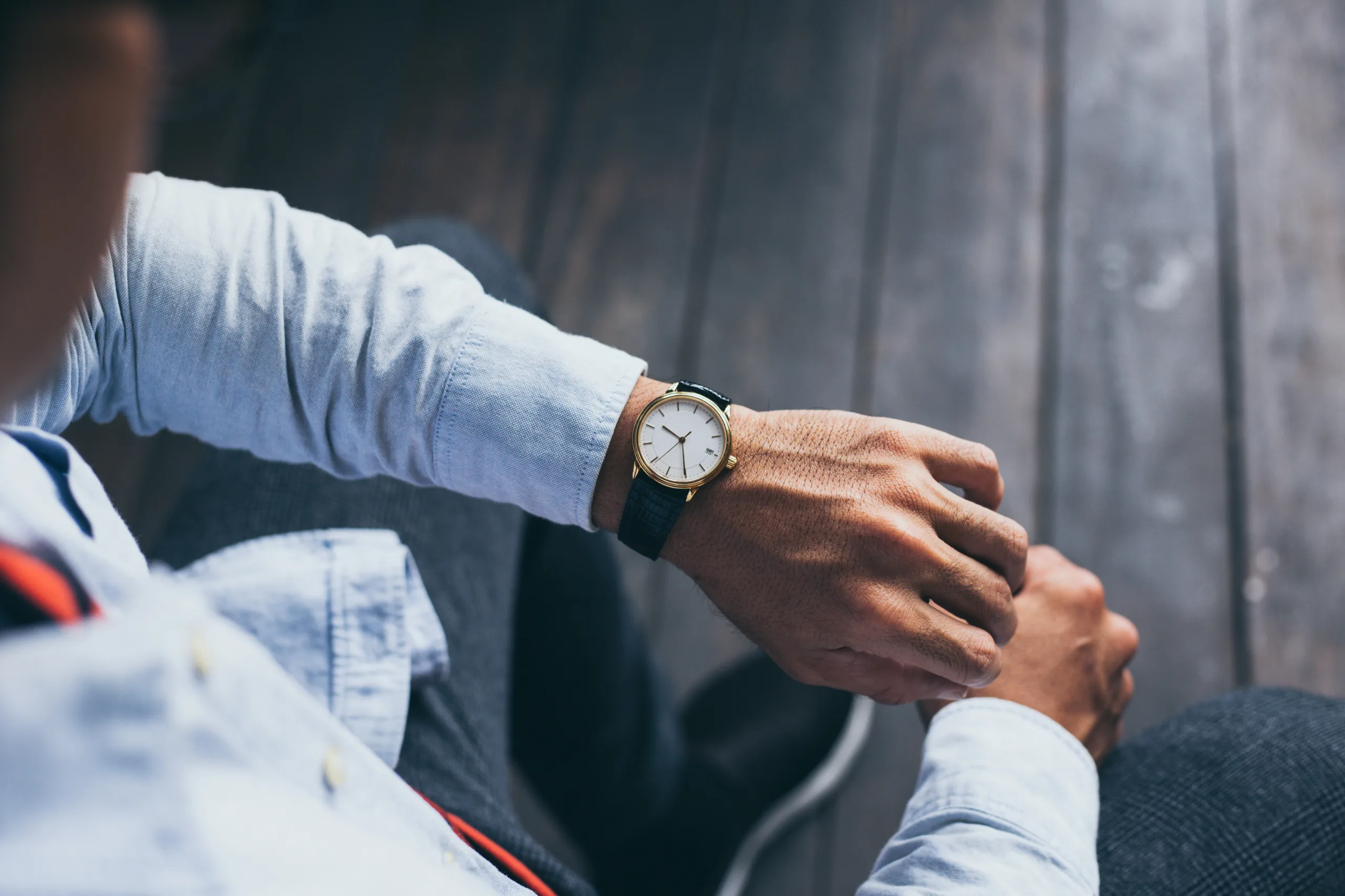 man fashionable wearing stylish looking at luxury watch on hand check the time at workplaceconcept for managing time organization workingpunctualityappointment - 人形町・水天宮前のセミパーソナルジム|LYRIM人形町・水天宮前店 腕時計で時間を確認している男性